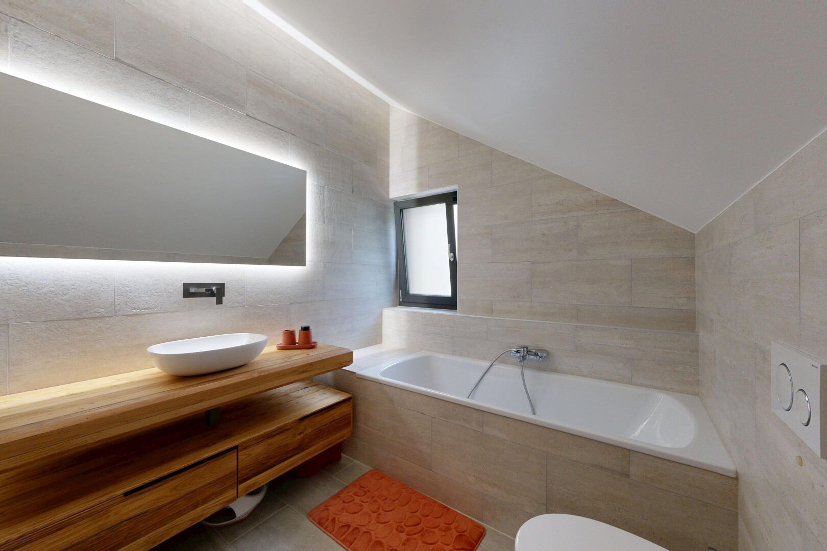 bathroom featuring tile walls, a bath, vanity, and vaulted ceiling