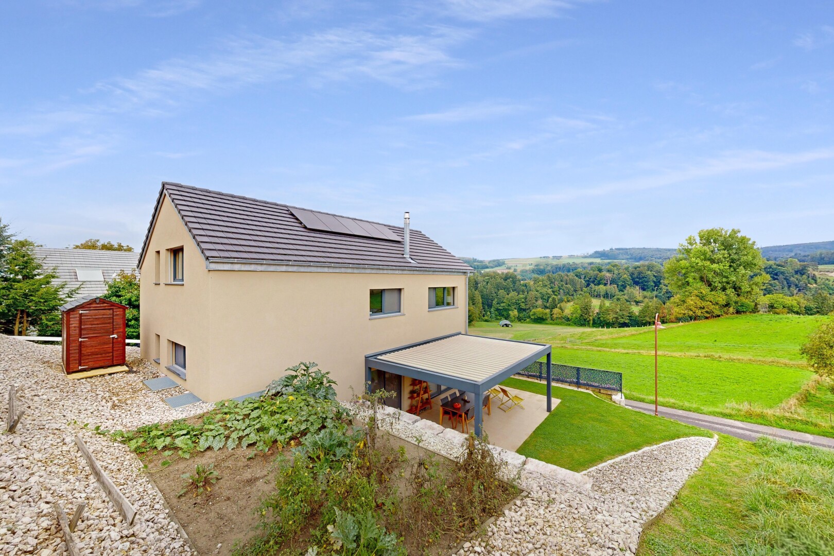 view of home featuring stucco siding and solar panels