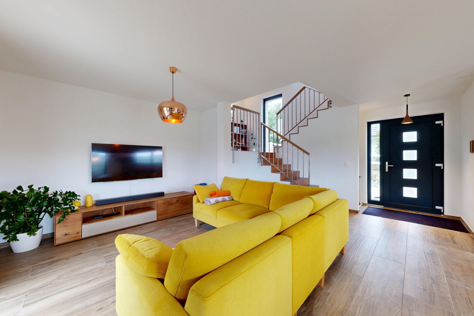 living area with wood finished floors and stairway