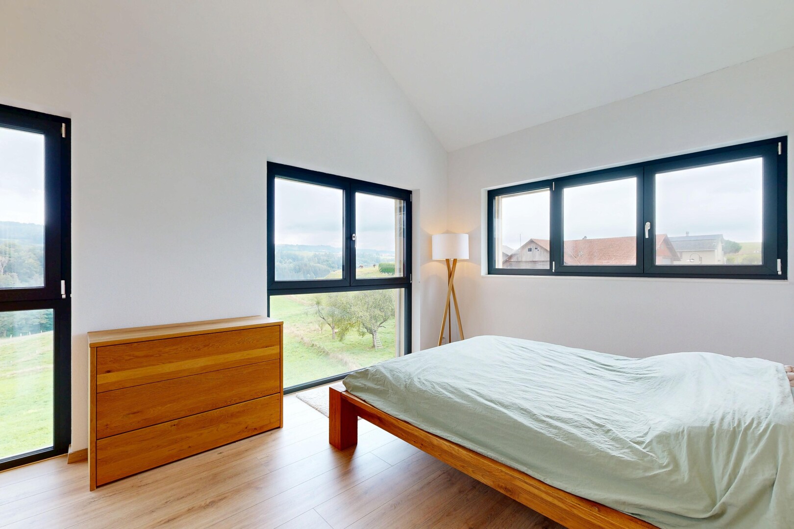 room with light wood-type flooring and high vaulted ceiling