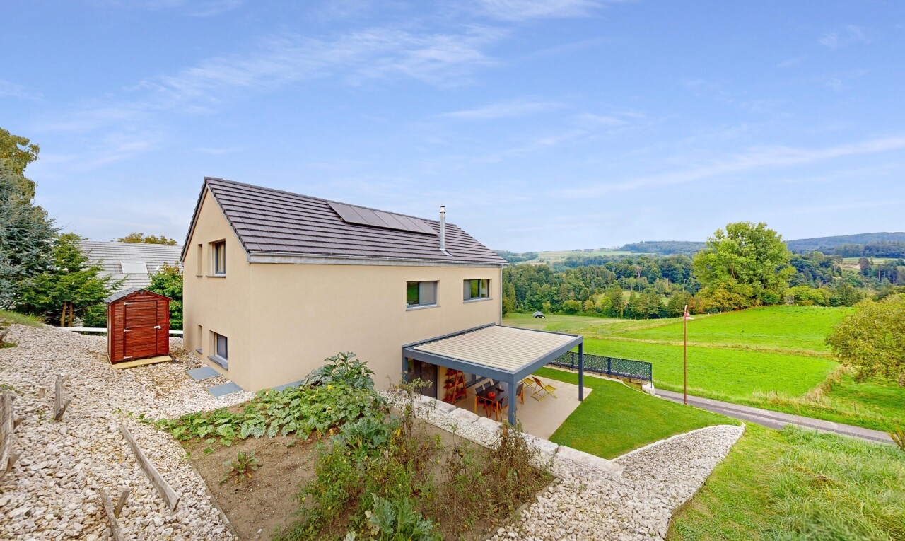 view of home featuring stucco siding and solar panels