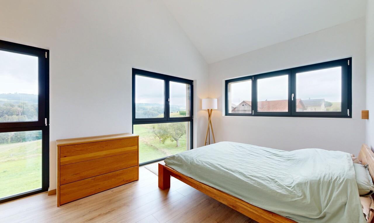 room with light wood-type flooring and high vaulted ceiling