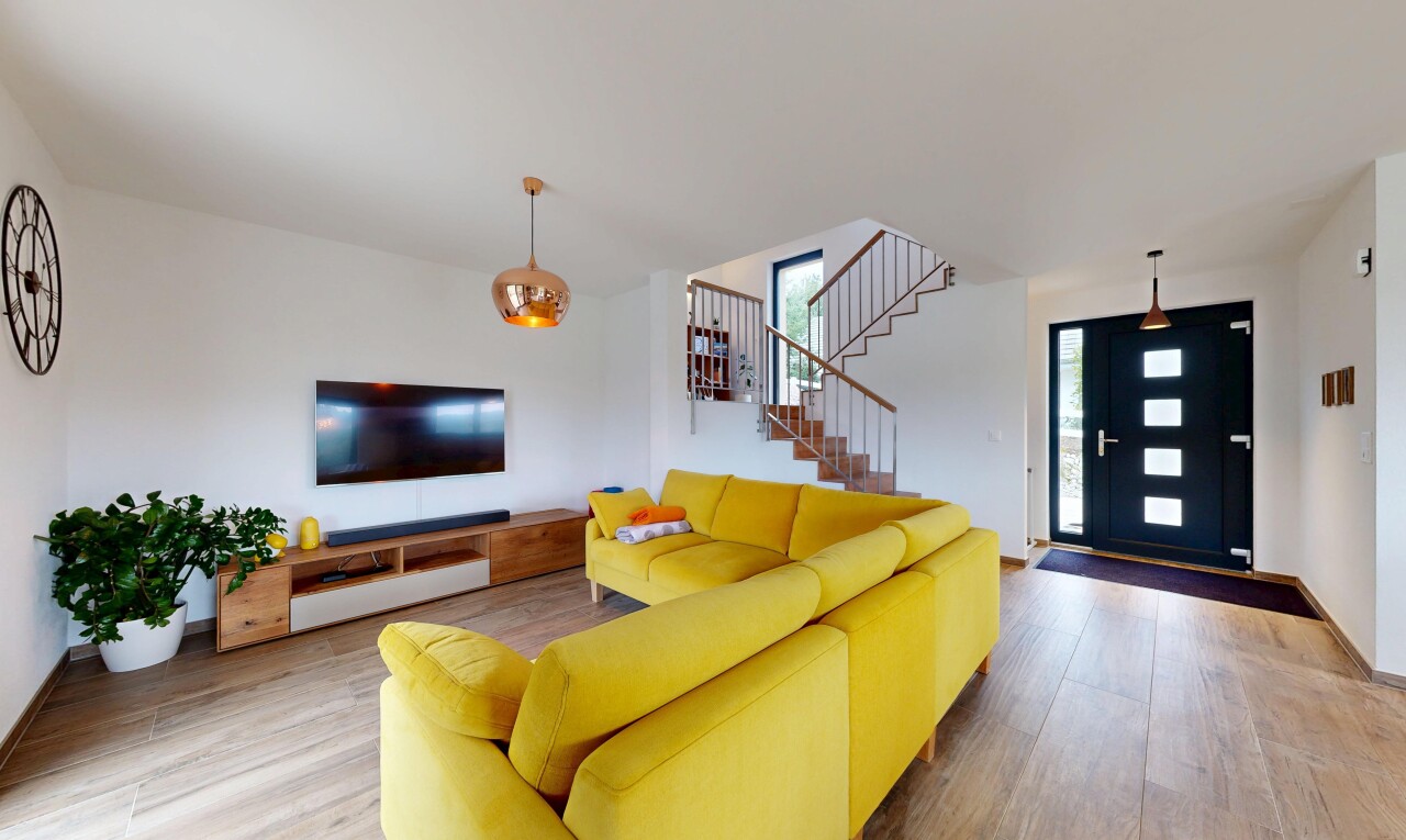 living area with wood finished floors and stairway