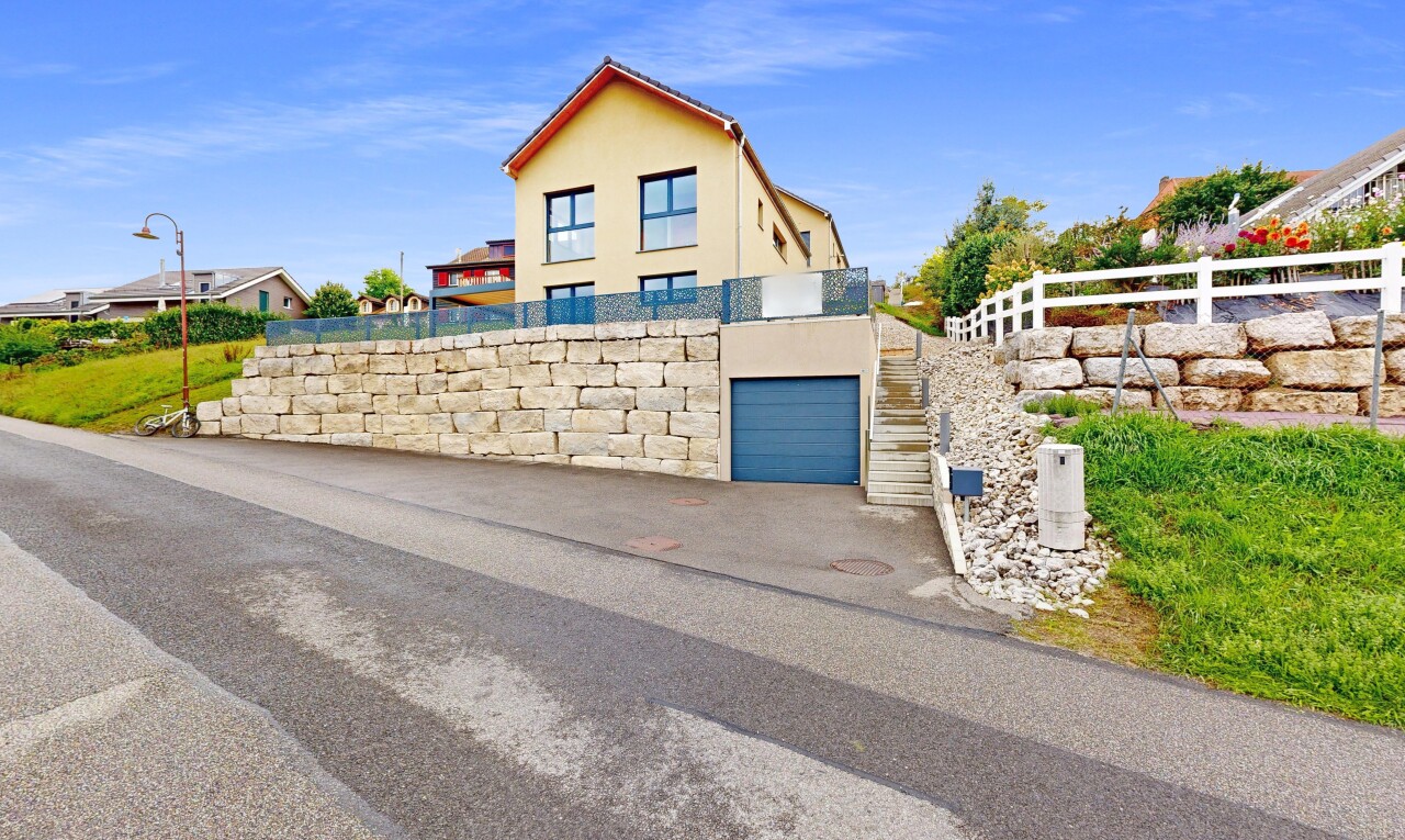 outdoor house with stucco siding and an attached garage