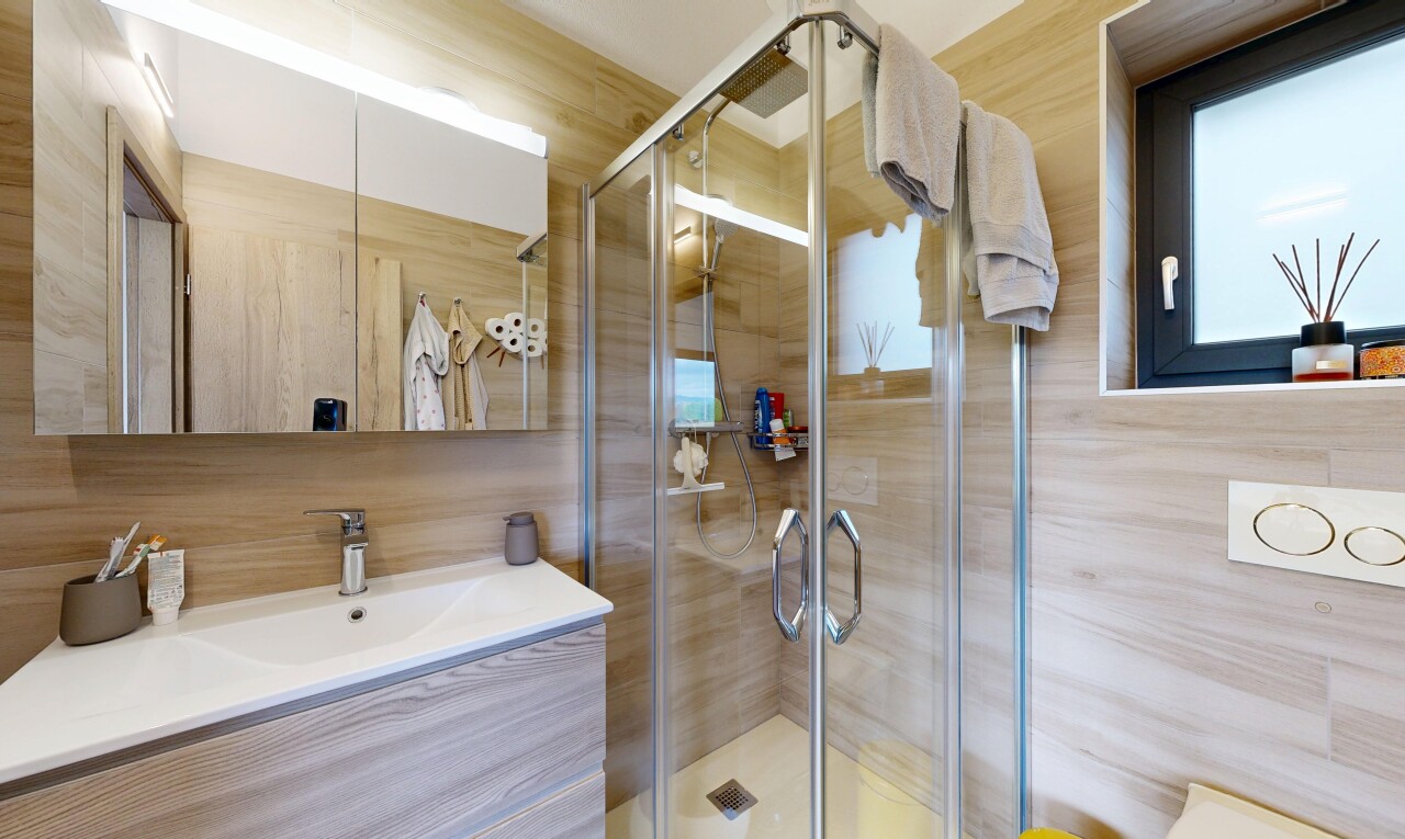 full bathroom with vanity and a stall shower