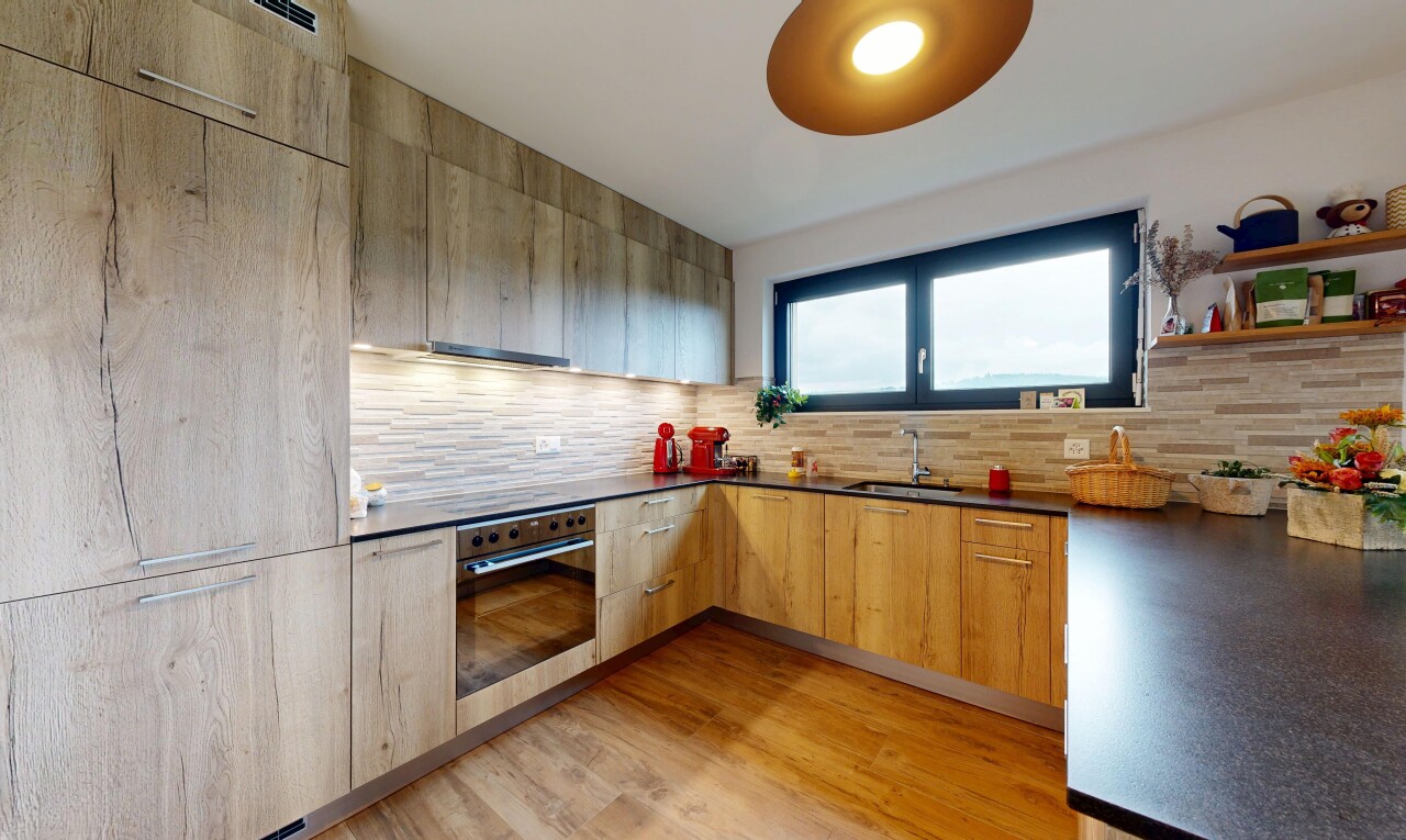 kitchen featuring modern cabinets, light wood-type flooring, oven, and tasteful backsplash
