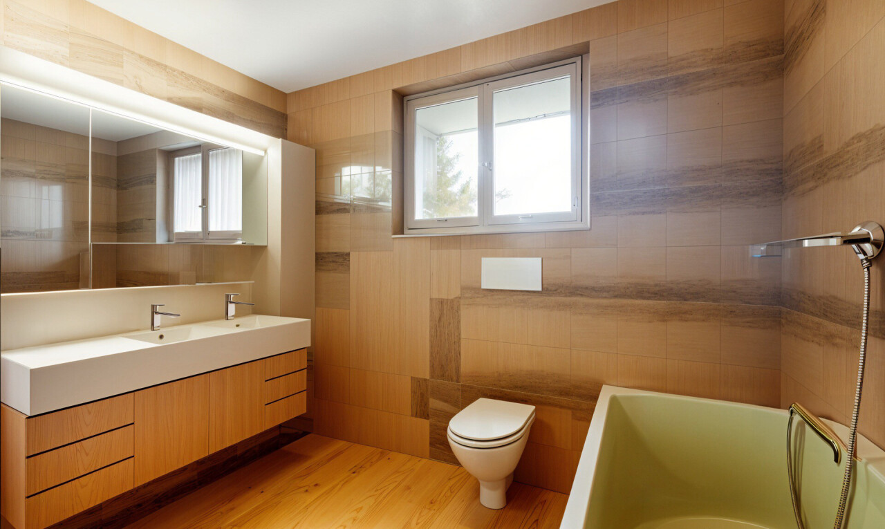 salle de bains avec lumière naturelle, miroir, meuble-lavabo, plancher de bois, et mur carrelé