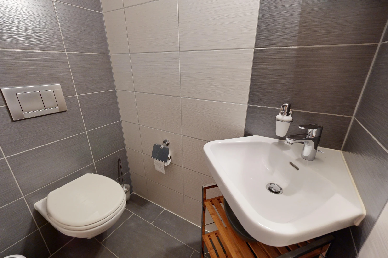 bathroom featuring tile patterned floors, vanity, toilet, and tile walls