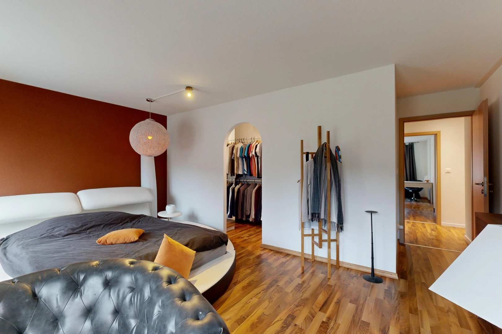 room / bedroom with a closet, a spacious closet, and dark hardwood / wood-style flooring