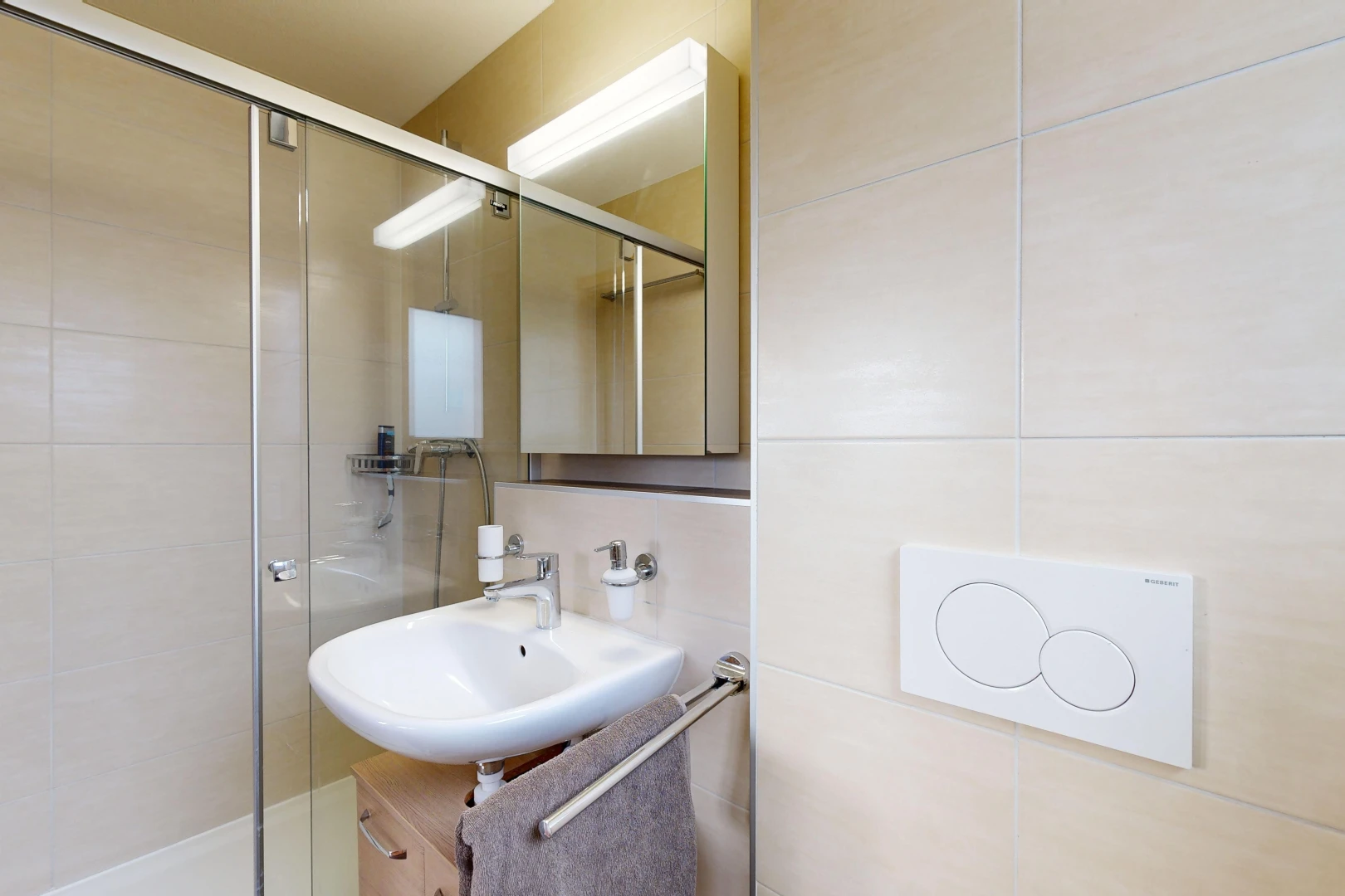 bathroom featuring backsplash, sink, a shower with door, and tile walls