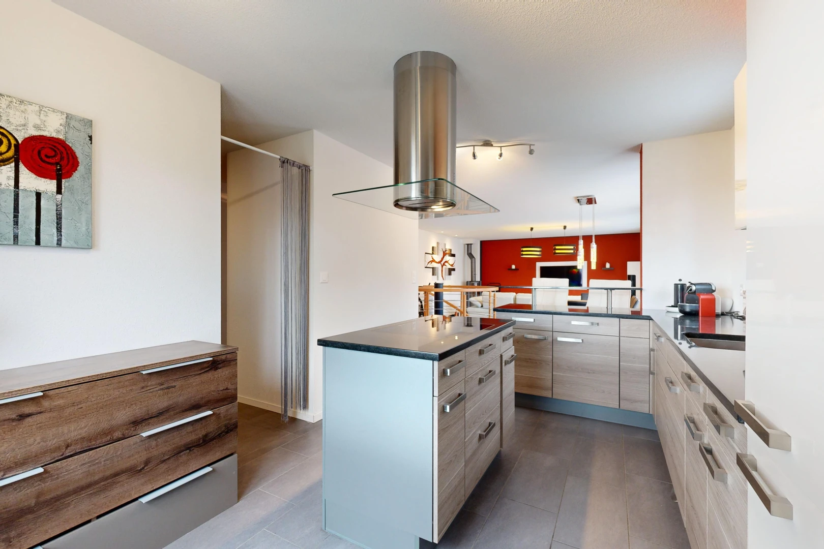 kitchen featuring decorative light fixtures, a kitchen island, sink, and island exhaust hood