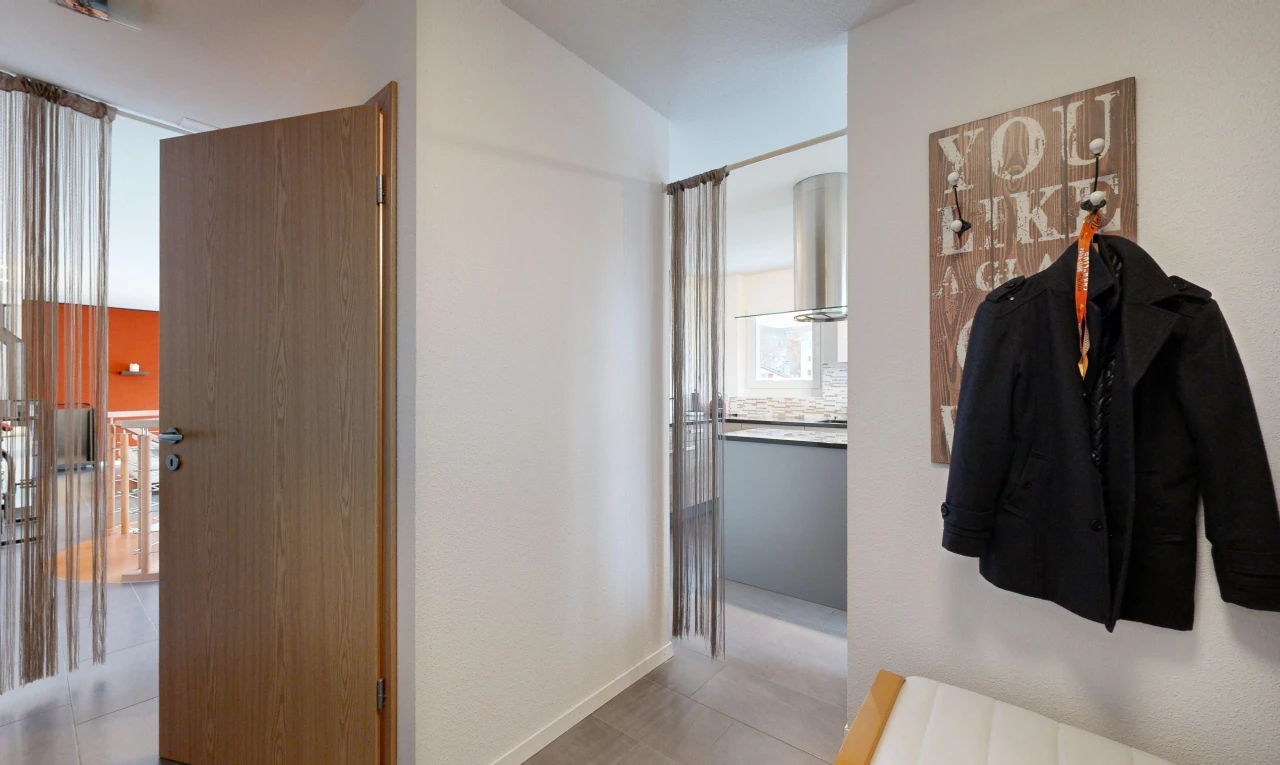 hall / corridor with light tile patterned floors