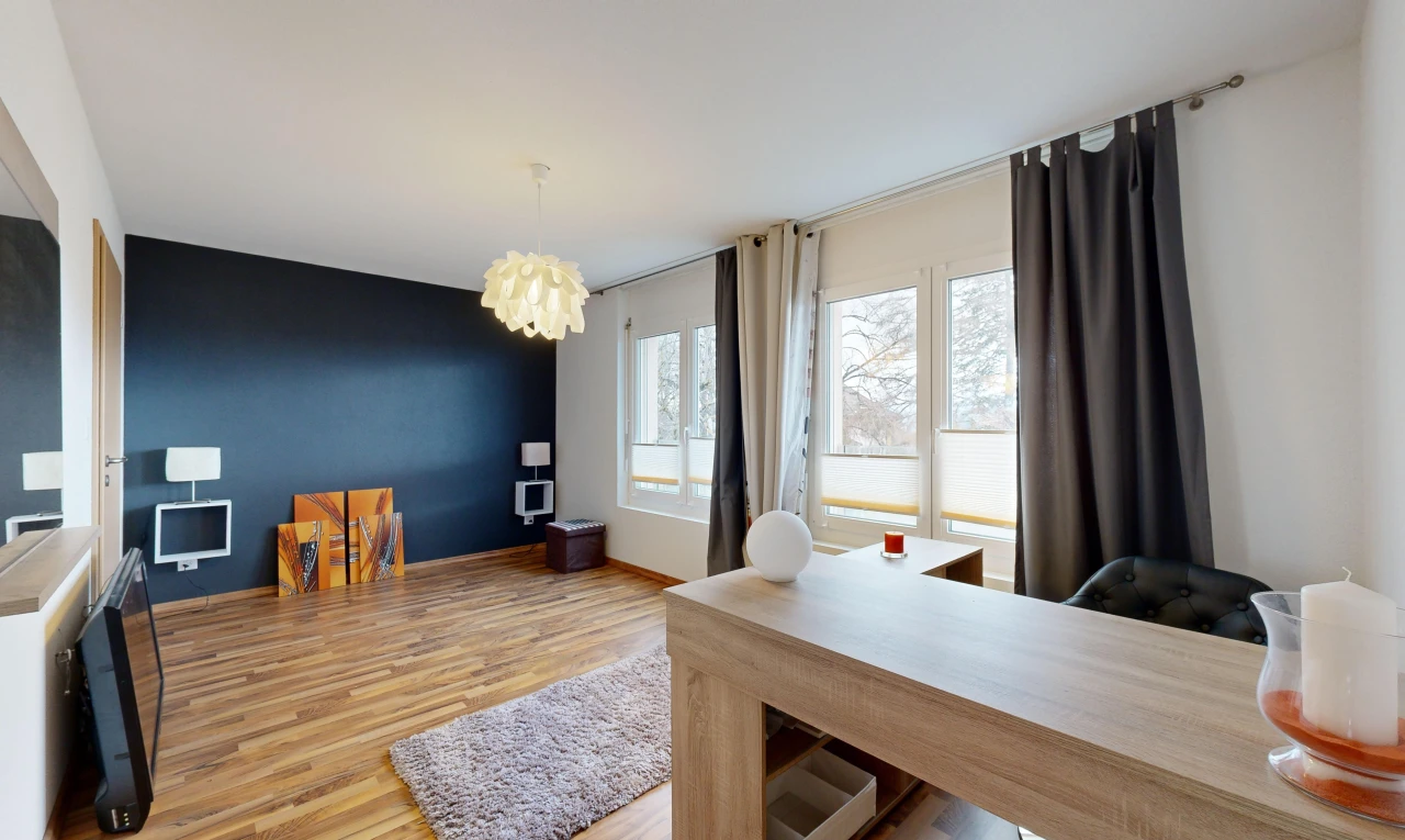 living / dining room with a notable chandelier and light hardwood / wood-style floors