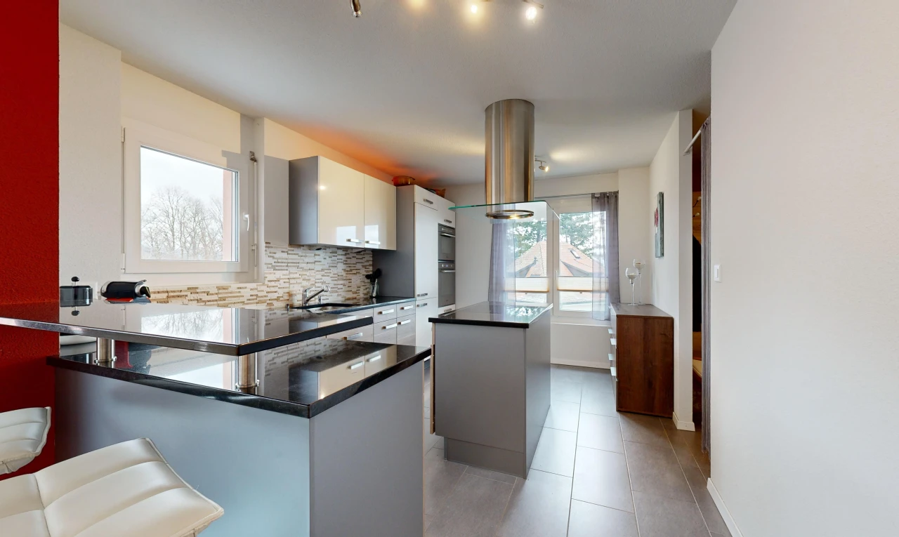 kitchen featuring white cabinetry, backsplash, a wealth of natural light, and a center island