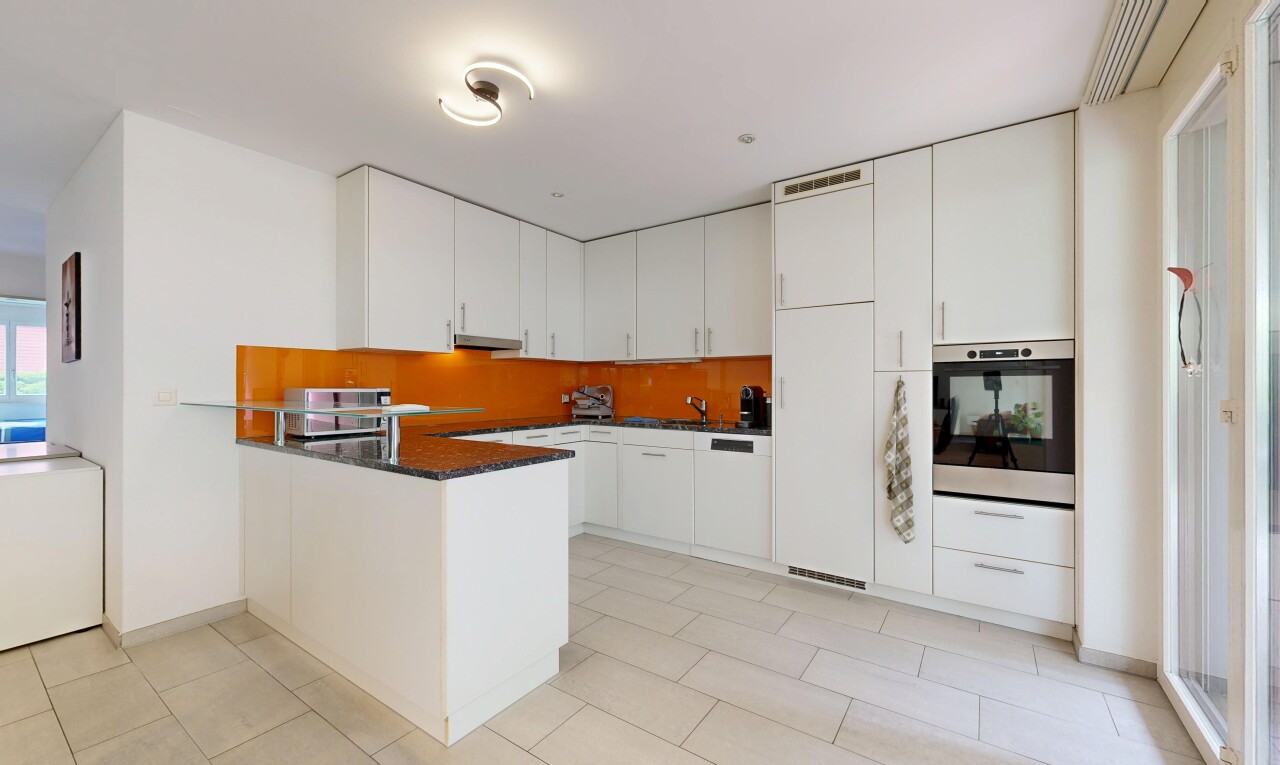cuisine avec dark countertops, four, light floor, kitchen peninsula, et péninsule de cuisine
