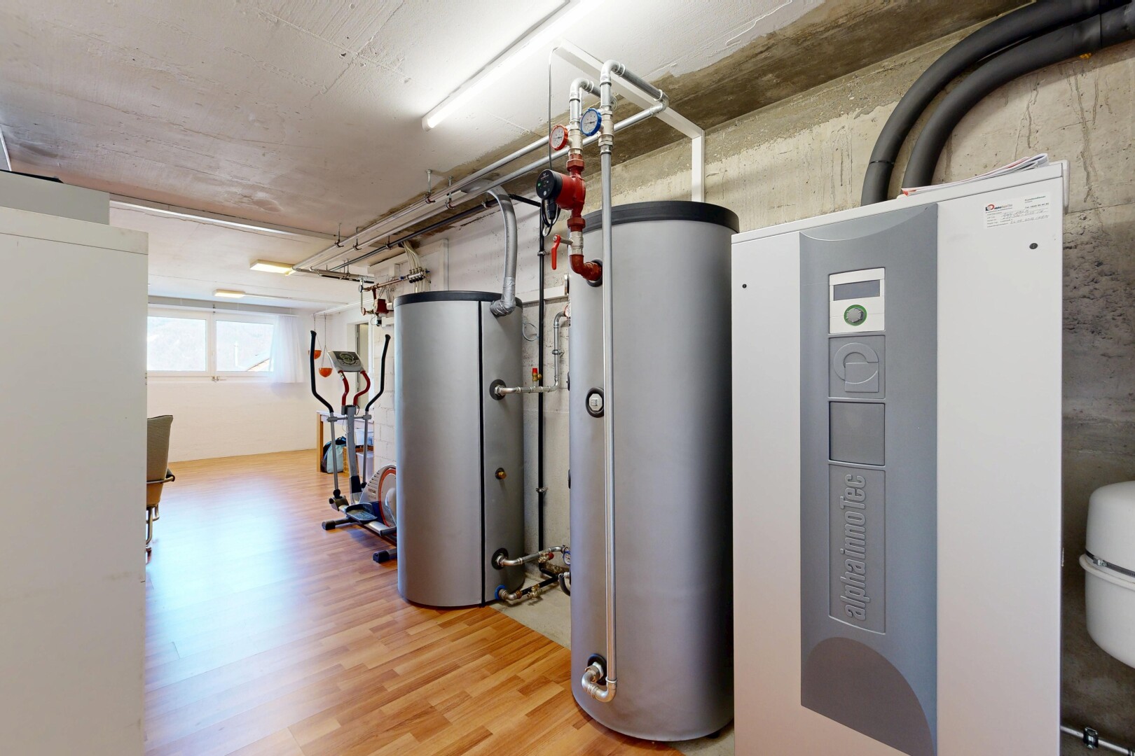 gym avec inside community, chauffe-eau, natural light, wood finish floor, et light floor