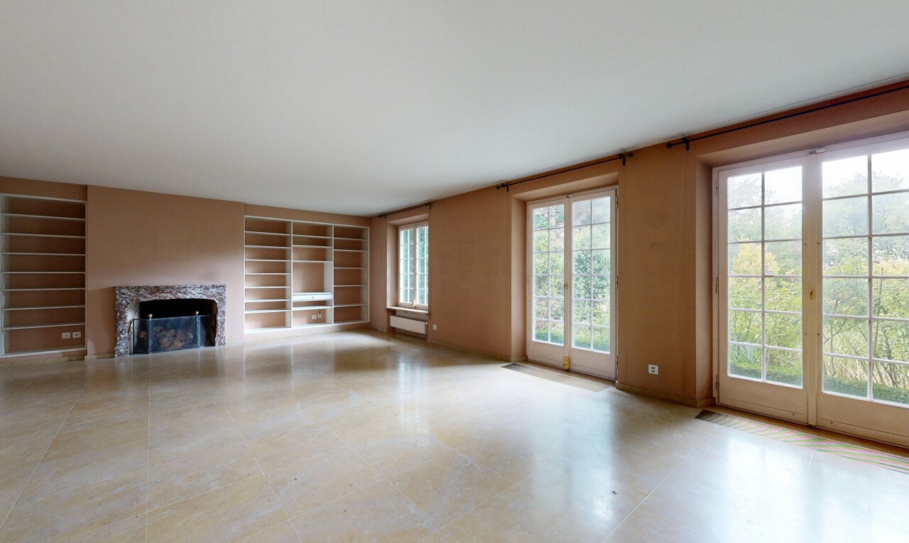 leerer raum mit inside property, eingebaute regale, built in shelves, kamin, und natürliches licht