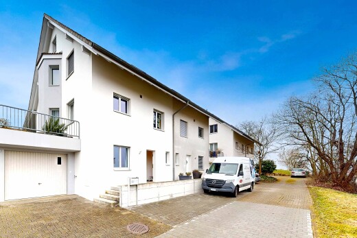 outdoor house with a balcony and stucco siding