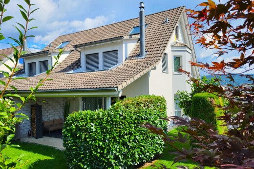 view of property featuring a tiled roof and stucco siding