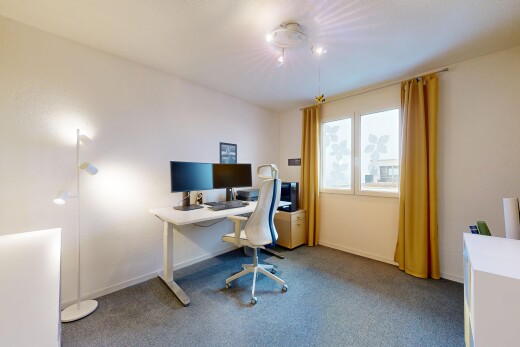 carpeted office space with baseboards