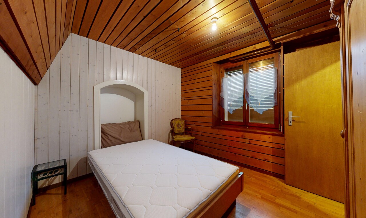 chambre avec wood finish floor, sol en finition bois, wood ceiling, plafond en bois, et wood wall