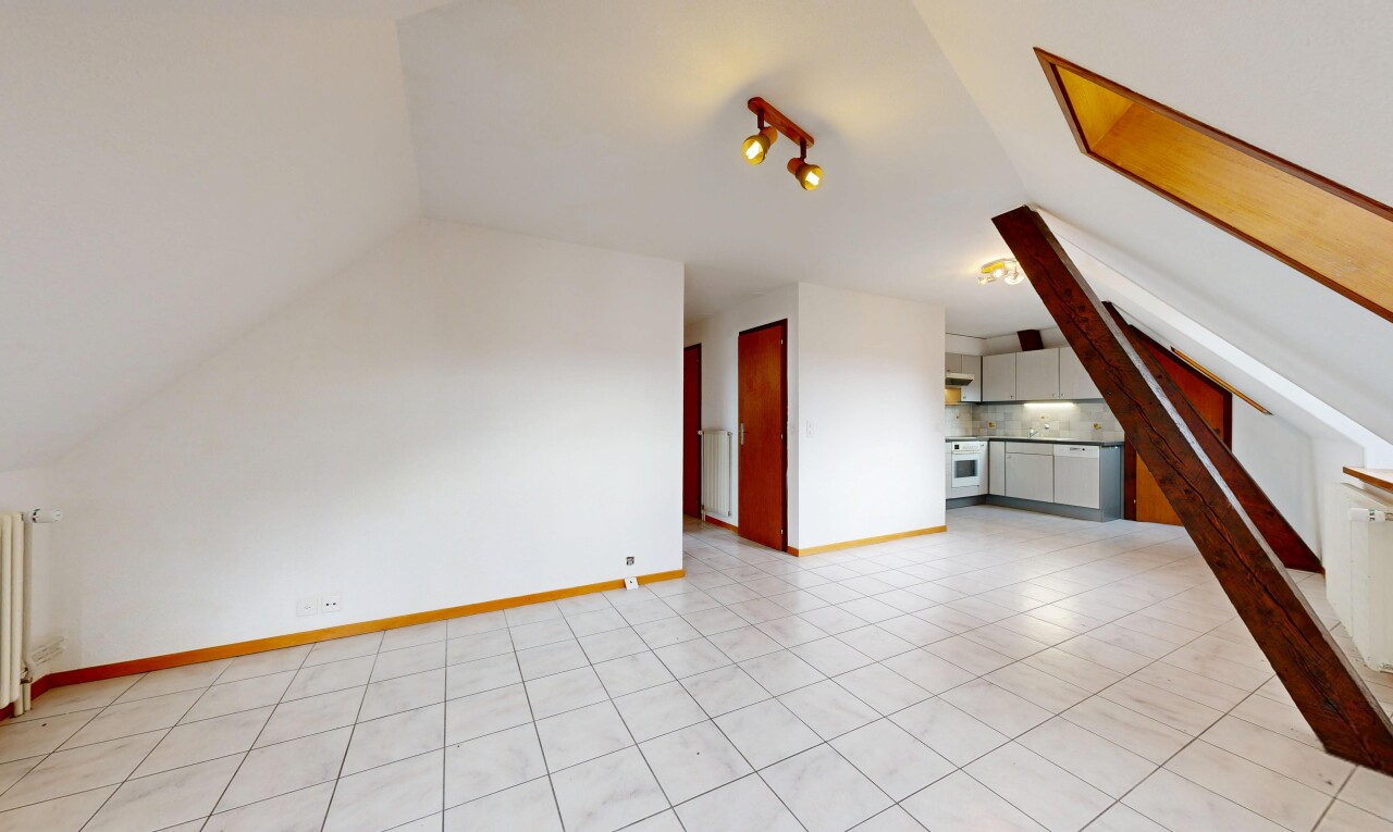 pièce vide avec light floor, vaulted ceiling, plafond voûté, drywall, et cloison sèche