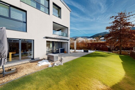 view of home featuring stucco siding, a yard, a mountain view, a balcony, and a patio area