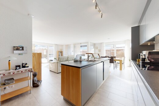 kitchen featuring a center island, dark countertops, open floor plan, black electric stovetop, and modern cabinets