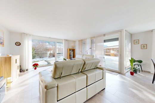 living area featuring plenty of natural light and a wall of windows