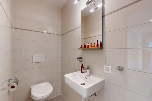 half bath featuring tile walls