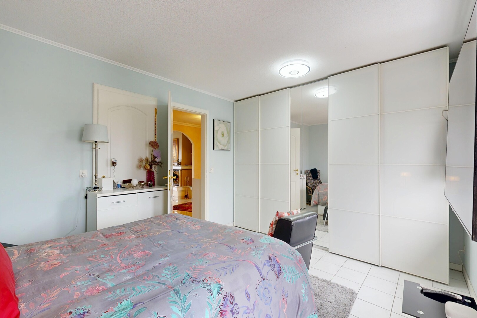 room featuring light tile patterned floors and a closet