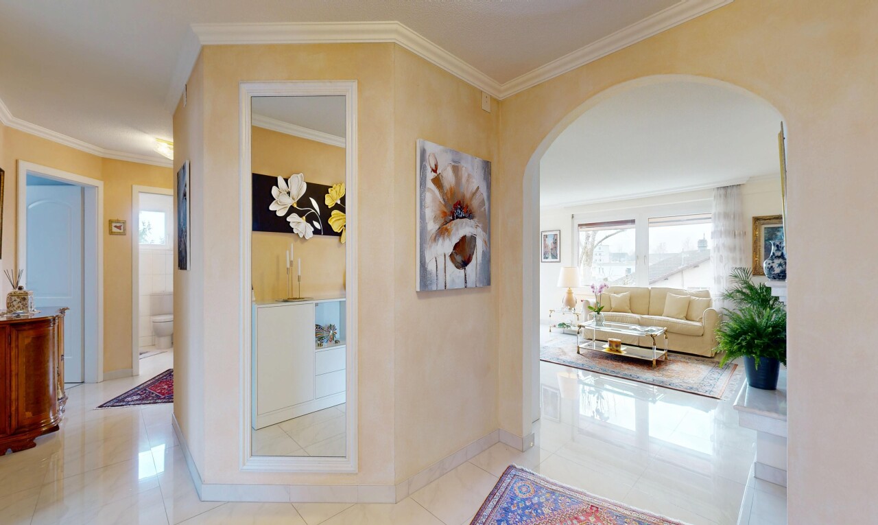 hallway featuring ornamental molding, arched walkways, and light tile patterned flooring
