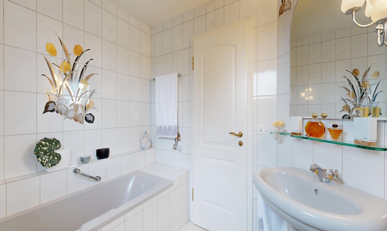 full bathroom featuring tile walls and a garden tub