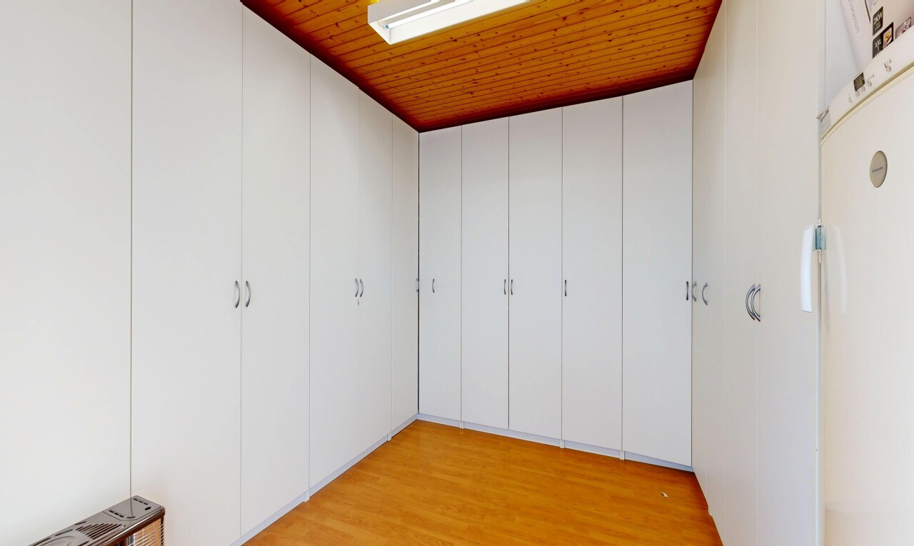 unfurnished room with light wood-style flooring and freestanding refrigerator