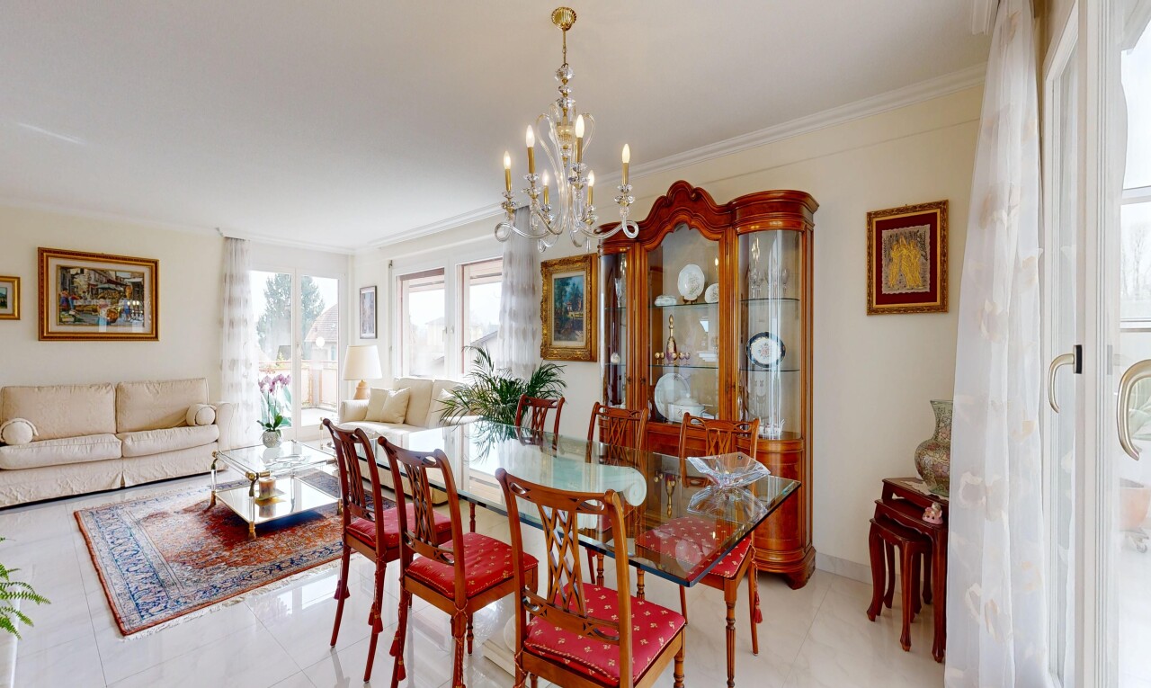 living / dining room featuring crown molding and hanging lights