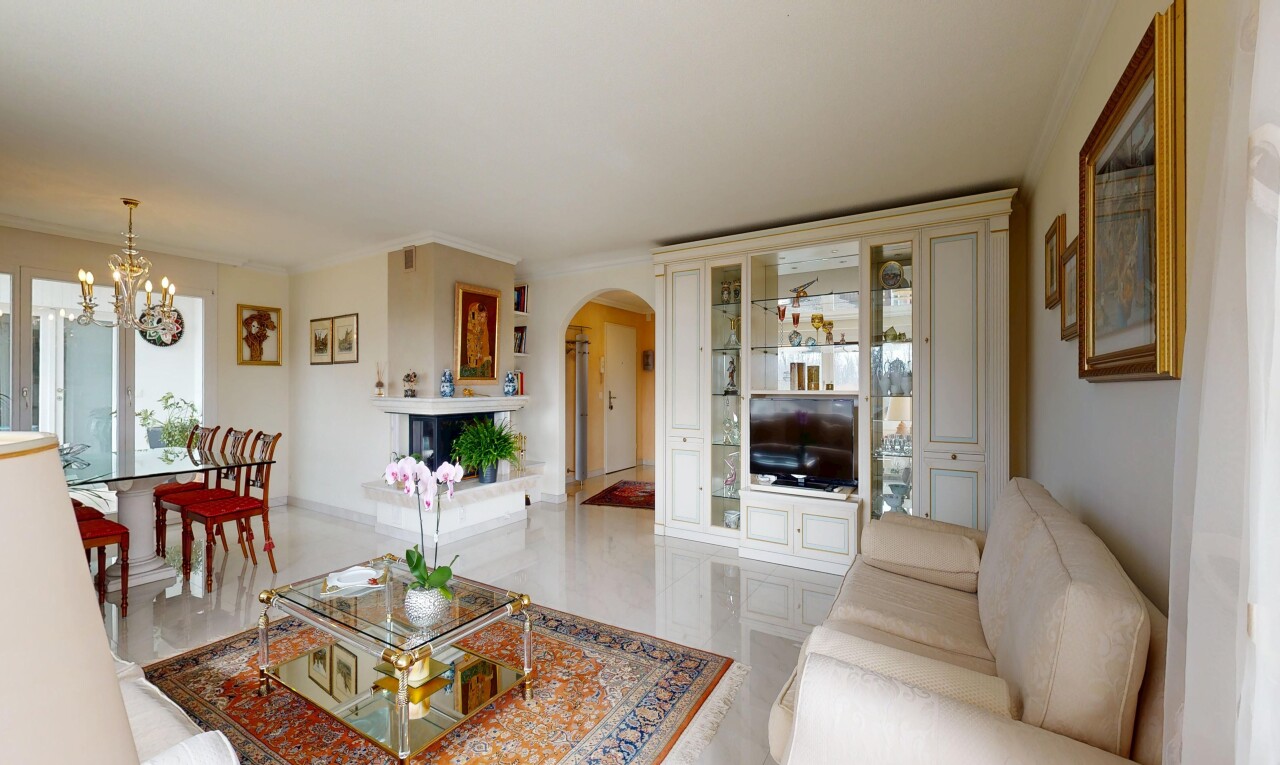 living / dining room with arched walkways, ornamental molding, and suspended lighting