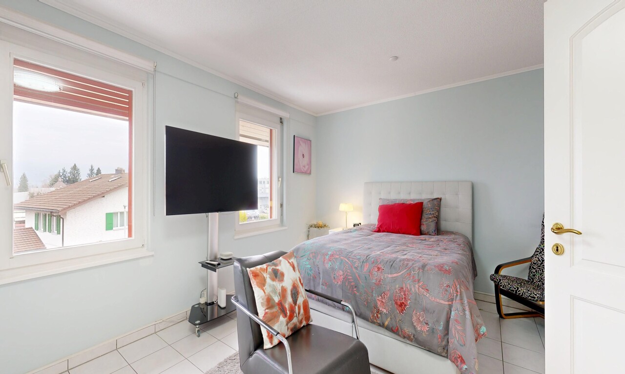 room with ornamental molding and light tile patterned floors