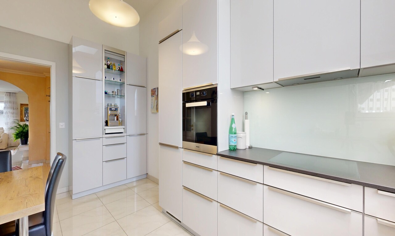 kitchen with oven, white cabinetry, modern cabinets, light tile patterned flooring, and arched walkways
