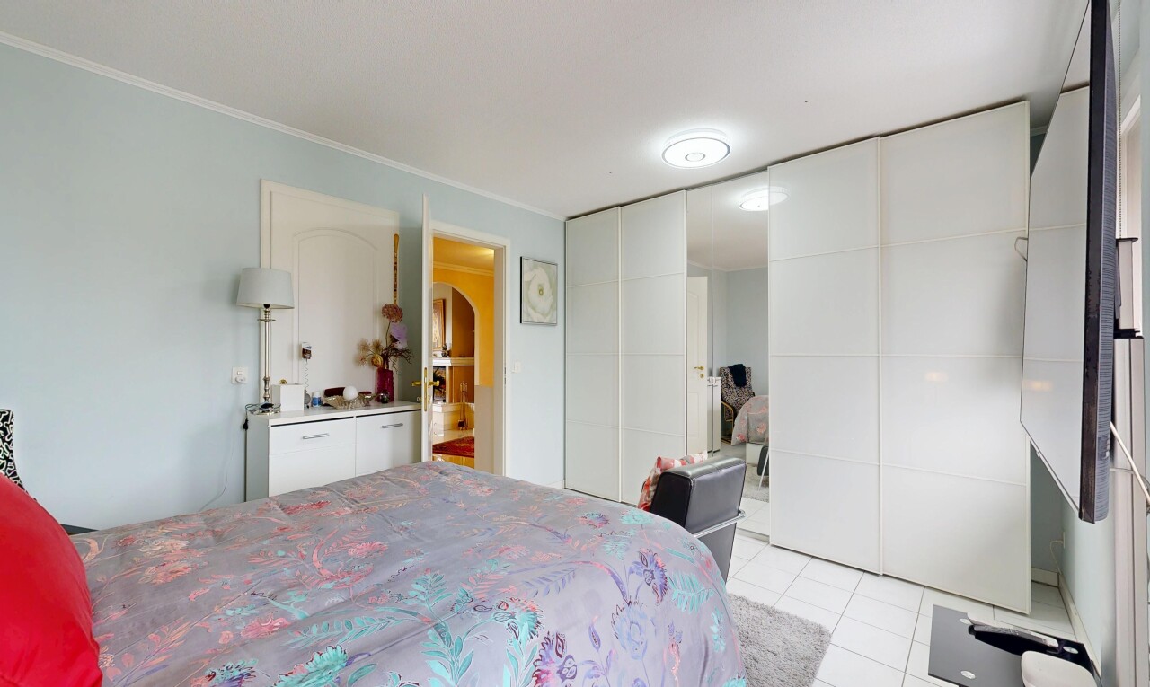 room featuring light tile patterned floors and a closet