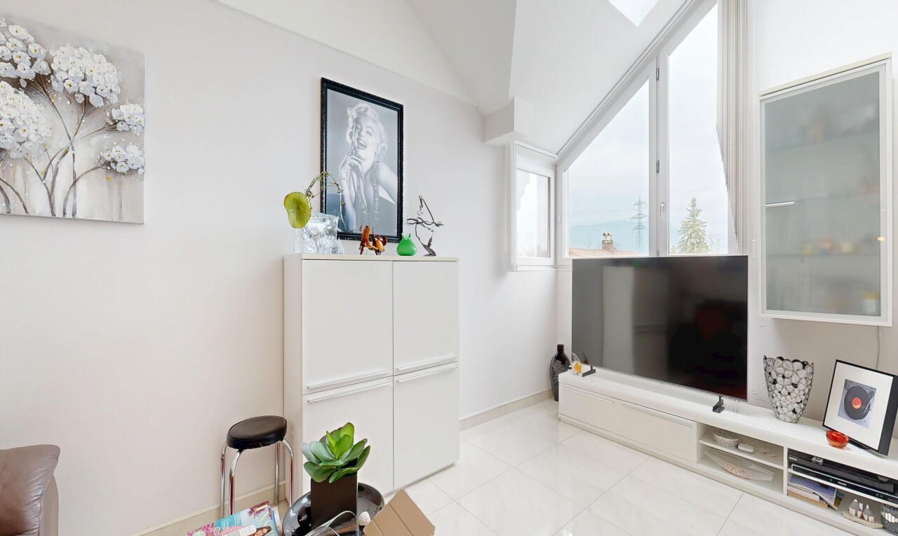 living area featuring vaulted ceiling and light tile patterned floors