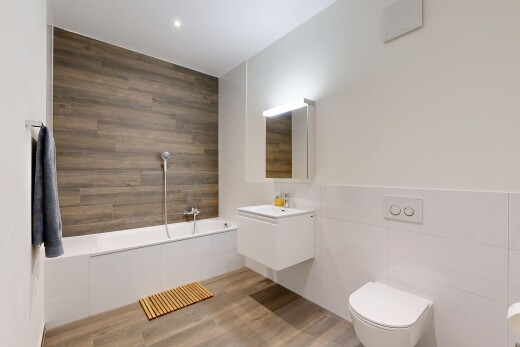 salle de bains avec tile wall, mur en carrelage, salle de bain complète, lavabo (ou coiffeuse selon le contexte), et miroir