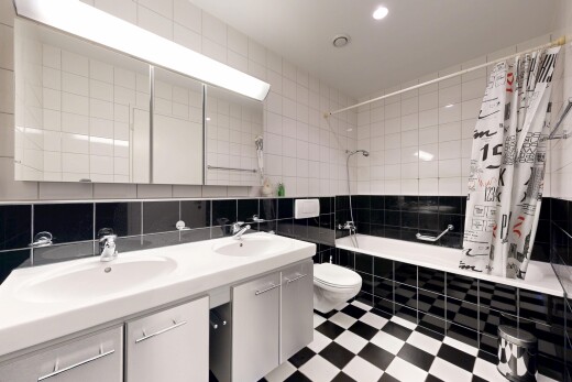 full bath featuring tiled shower / bath, tile walls, double vanity, light flooring, and recessed lighting