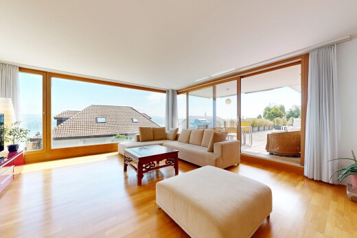 living room featuring light wood finished floors, healthy amount of natural light, and floor to ceiling windows