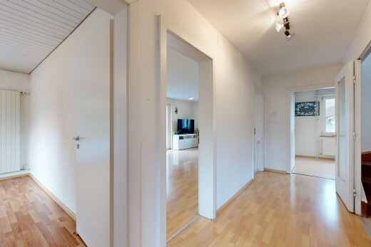 hallway with light wood-style floors and radiator