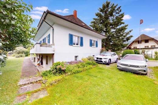 view of property featuring a yard, a chimney, and stucco siding