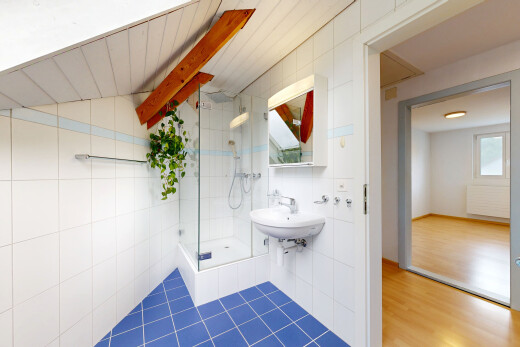 bathroom featuring tile walls, a stall shower, and radiator heating unit