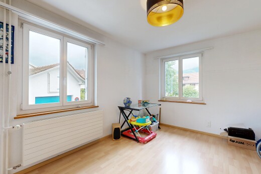 empty room featuring radiator and wood finished floors