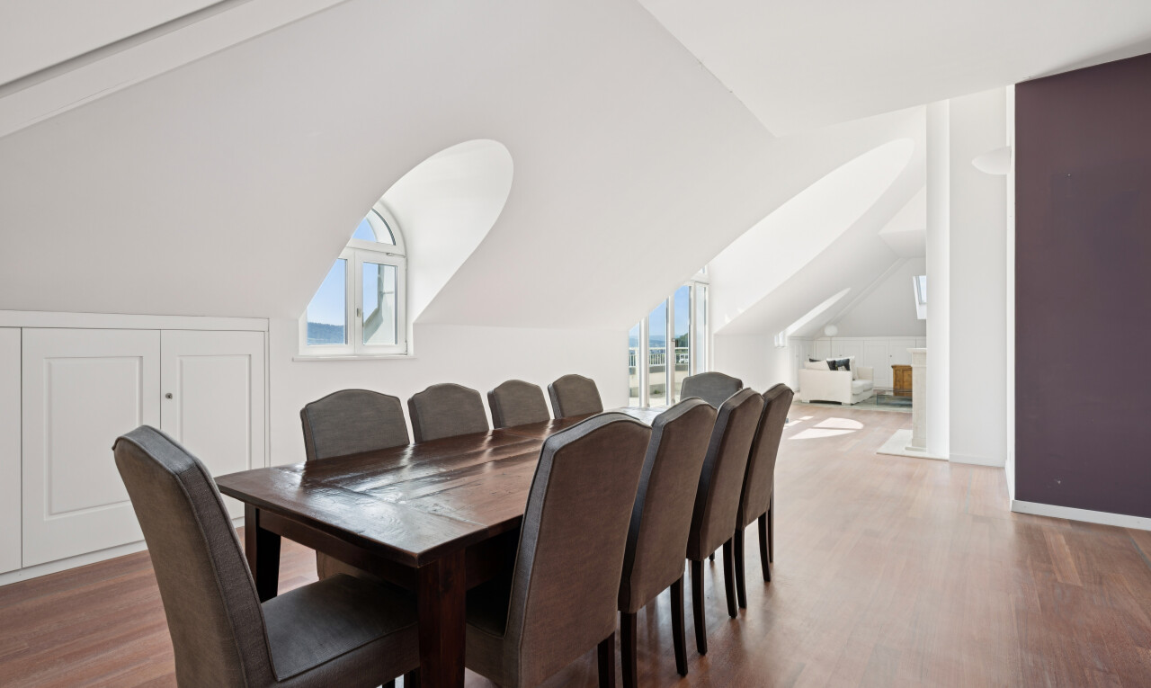 dining space featuring wood finished floors and lofted ceiling