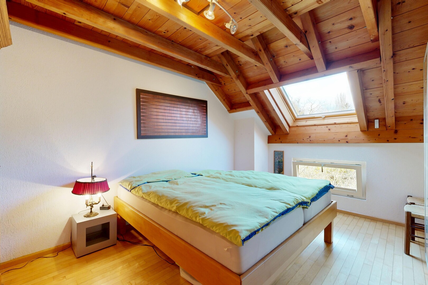 chambre avec inside property, sol en finition bois, wood finish floor, plafond à poutres, et beamed ceiling