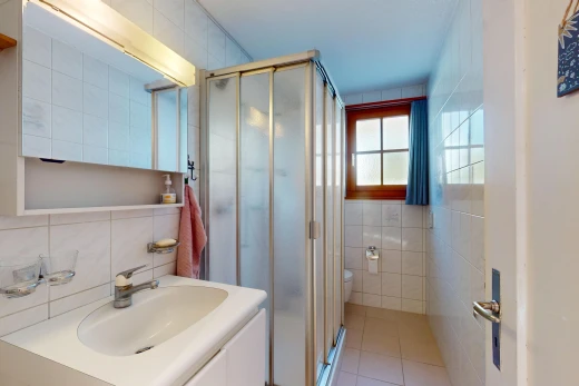 bathroom featuring tile walls, a shower with shower door, and tile patterned floors